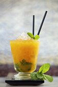 Passion Mojito (cocktail made with rum, passion fruit liqueur, passion fruit puree, lime juice, sugar syrup and mint)
