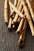 Cinnamon sticks on a wooden surface (close up)