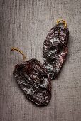 Two dried Poblano chili peppers