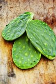 Cactus leaves without spikes on a wooden surface