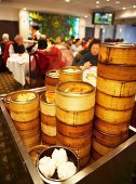 Lots of bamboo steamers filled with dim sum on a trolley in a Chinese restaurant