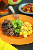 Beef with a chill and mango salsa and corriander