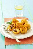 Deep-fried mini empanadas stuffed with minced meat and beans