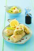 Rice paper rolls stuffed with fish and leek