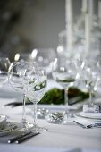 Wine glasses on a table laid for Christmas dinner