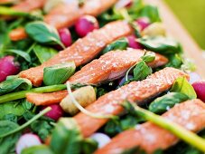 Oven baked rainbow trout with vanilla dressing on raw vegetables