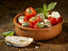 Cherry tomatoes stuffed with a herb and cream cheese filling and mini peppers stuffed with a pesto and cream cheese filling