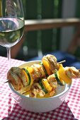 Grilled kebabs and a glass of white wine