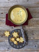 Cheese cream soup in a small pan with Parmesan stars
