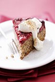 A piece of cranberry cake with whipped cream
