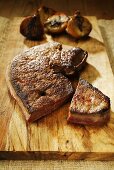 Fried calf's liver with onions on a wooden board