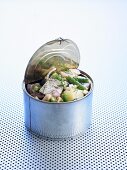 Matjes herring, potato and bean salad in a tin