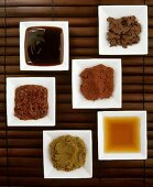 Six different spicy Asian sauces in small dishes