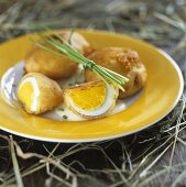 Boiled eggs fried in batter with chives for Easter