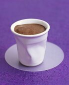 Coffee cream in a dented beaker
