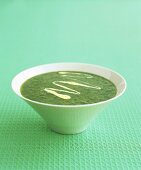 A bowl of parsley soup with saffron cream