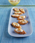Crostini topped with garlic and bean puree