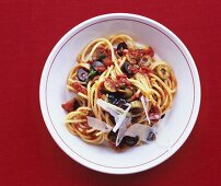 Spaghetti with tomato and anchovy sauce and olives