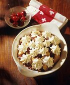 Cherry and apple pudding with meringue rosettes