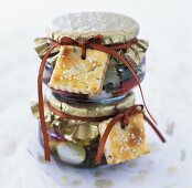 Mozzarella in oil in preserving jars with rosemary biscuits