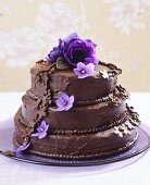 Three-tiered chocolate cake with flowers