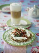 Cream cheese and vegetables on wholemeal bread, latte macchiato