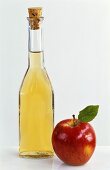 Bottle of cider apple vinegar with fresh apple