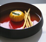 Baked mini pumpkin stuffed with cheese in a glass bowl