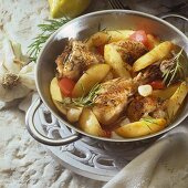 Lemon chicken with potatoes, tomatoes and rosemary