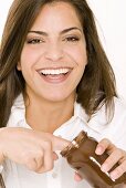 Young woman eating chocolate spread from the jar