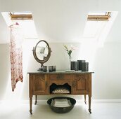 Mirror and containers on an old sideboard