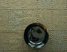 Tablecloth decorated with beads & wooden bowl