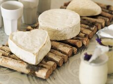 Camembert cheeses on mat made of sticks