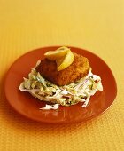 Breaded salmon fillet on cabbage salad (California, USA)