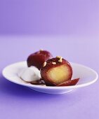 Plums in syrup with pine nuts