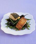 Fried salmon on beetroot and beans