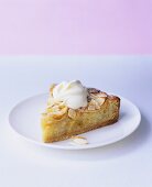 A piece of apple and almond tart with whipped cream