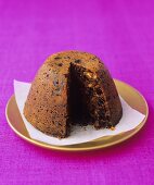 Christmas pudding with a portion taken (UK)