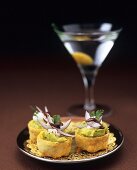 Small guacamole tarts, glass of Martini