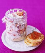 Crabmeat in dill cream sauce in storage jar, blinis