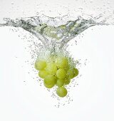 Green grapes falling into water