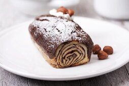 Chocolate-hazelnut Swiss roll dusted with icing sugar