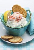 Prawn dip with crackers and sliced lemon