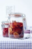 Plum compote in preserving jars with a label