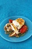 Chicken breast with almond crust on tomatoes and shallots