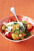 Pan-fried chicken and gnocchi with tomatoes and rocket