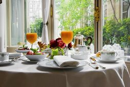 Laid breakfast table with multivitamin juice