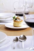 Vol-au-vent and red wine on laid table
