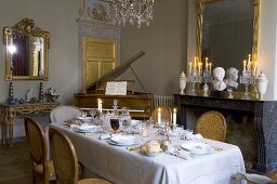 Table laid for special occasion, piano in background