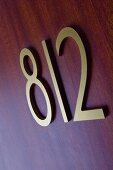 Room number on the door of a hotel room
